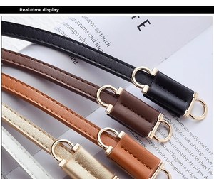 Detail showing five colored PU leather belts with fine stitching and gold D-ring buckles
