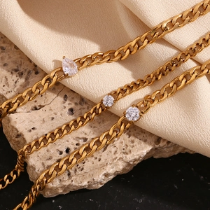 Detail of 18K gold plated chains with marquise and round zircon on stone base