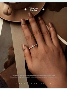 Close-up of a 925 silver ring featuring a 3D four-pointed star on a hand over a coffee cup