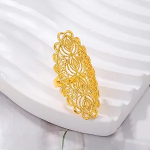 Macro shot of intricate filigree patterns and golden texture on an oversized hollow ring