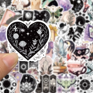 Macro view of heart-shaped wizard style sticker with floral and mystical line art patterns