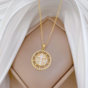 Detailed close-up of golden cross necklace with shimmering diamonds on elegant silk fabric
