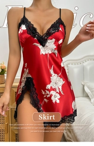 Detail of red silk nightdress featuring white floral print and black lace trim on side slit