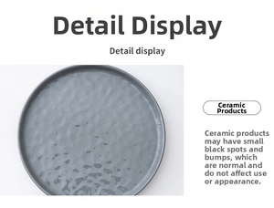 Detail display of grey ceramic dinner plate showing textured surface and matte finish
