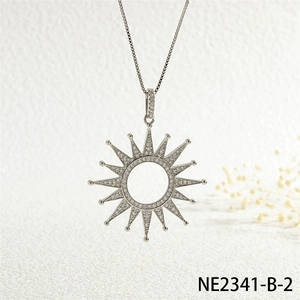 Detailed view of silver sunburst pendant with hollow center and pavé zircon stones