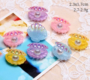 Macro detail of colorful resin shell pendants with pearls for DIY jewelry making
