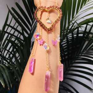 Detail of bohemian gold heart suncatcher armlet with pink crystals and butterfly charms