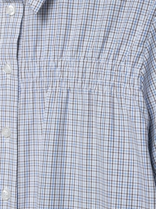 Detail of blue and white checkered shirt showing smocking texture and white buttons