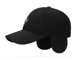 Detail view of winter baseball cap with ear flaps and side metal shield decoration