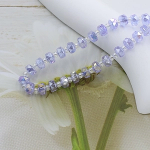 Detailed close-up of 6mm purple faceted crystal glass beads for DIY jewelry making