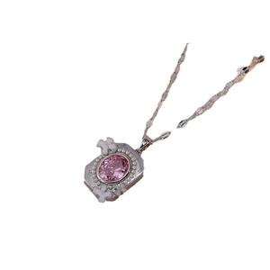 Floral necklace with pink oval gemstone and white flower detail on a silver chain