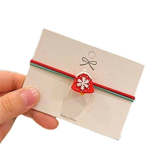 Christmas hair tie set featuring red bell charms with white snowflake patterns on card
