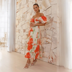 Detail of floral off-shoulder maxi dress featuring puff sleeves and layered skirt
