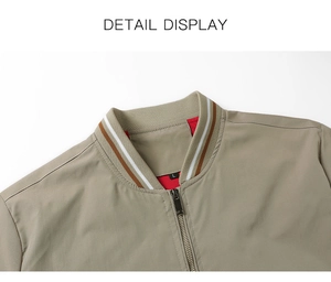 Detail of khaki jacket showing striped ribbed collar and metal zipper with red mesh lining
