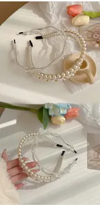 Detail of double-row pearl and crystal headband with elegant floral gold accents