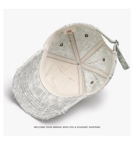 Detailed interior view of a washed grey baseball cap showing seam tape and inner label
