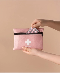 Pink portable medical organizer with smooth zipper and white first aid cross logo