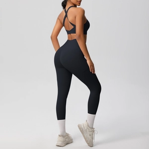 Detail of black seamless yoga set showing cross-back sports bra and high-waist leggings
