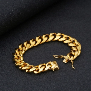 Close-up of golden stainless steel Cuban link bracelet with iced-out diamond inlay details