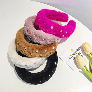 Detail shot of five plush headbands with pearls in rose, pink, camel, white, and black colors