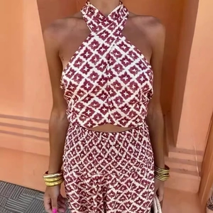 Women's two-piece halter cross neck top and floral print skirt set for vacation style