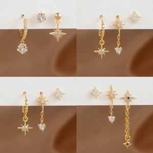 Macro display of gold star earrings set with micro-inlaid cubic zirconia stones