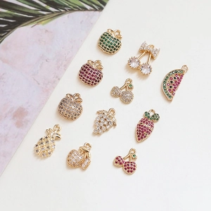 Detailed view of ten fruit-shaped gold metal pendants inlaid with colorful zircon stones