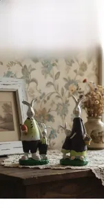 Close-up of four resin rabbits with vintage textured details in a rustic farmhouse decor