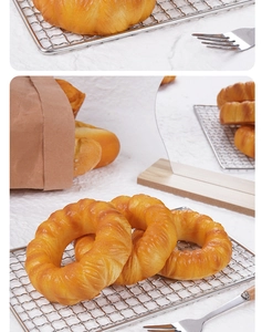 Close-up of realistic PU donut toy on a metal rack with warm lighting for food photography