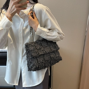 Chic black tweed crossbody bag with fringe texture and gold chain strap for women