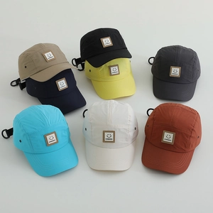Flat lay of colorful breathable quick-dry camper hats with smile patch and adjustable strap