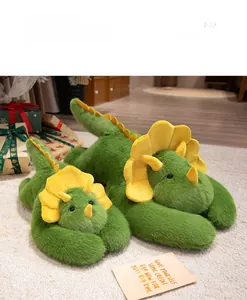 Detail of green triceratops plush slippers in two sizes on a white soft rug