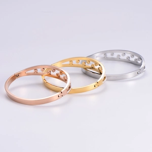Three-piece stackable 18k gold plated titanium bangles with sparkling diamond accents