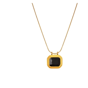 Vintage gold necklace with square black gemstone pendant on a flat snake chain