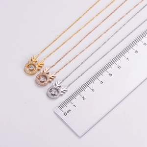 Detailed size measurement of a gold elk pendant necklace with a ruler showing 1.5cm width