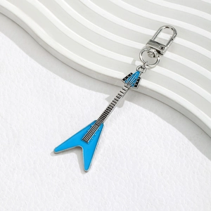 Detailed shot of a blue and silver Flying V electric guitar metal keychain pendant