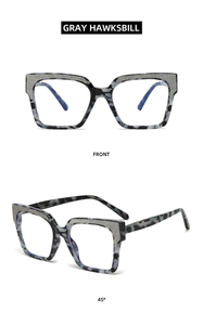 Detailed front and 45-degree views of gray hawksbill square frames with glitter inlay