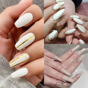 Three styles of long press-on nails with gold and silver stripes in coffin and almond shapes