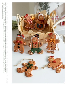Detailed view of hand-painted resin gingerbread man ornaments with festive scarves and bows