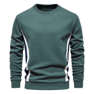 Macro view of stitching and navy white contrast panel on green cotton sweatshirt