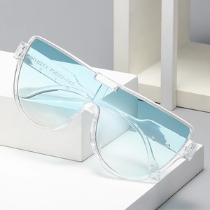 Oversized rimless blue sunglasses with transparent frame on a clean white display stand