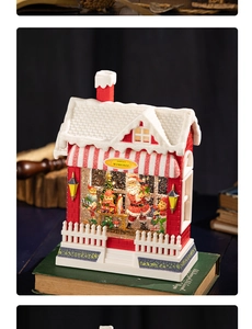 Detailed view of Santa's Workshop musical box with glowing lights on vintage books