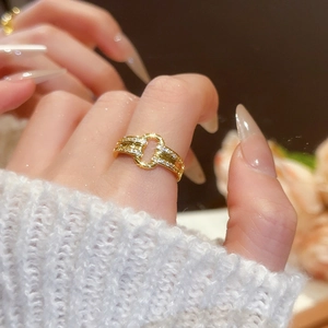 Detail of 18k gold plated open ring with pavé zircons worn on model finger