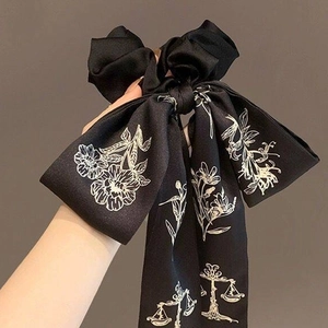 Floral print bow scrunchie with long ribbons in black satin for elegant hairstyles