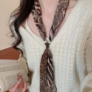 Close-up of leopard print chiffon scarf necklace with resin ring accessory for women