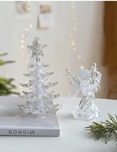 Close-up of clear acrylic Christmas tree and angel ornaments with sparkling glitter finish