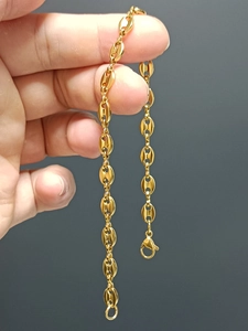 Detail of gold-plated stainless steel coffee bean link bracelet with lobster clasp