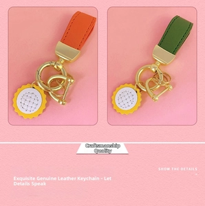 Detail view of premium leather keychains in orange and green with sunflower pendants
