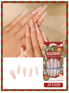 Macro view of Christmas press-on nails with candy cane stripes and red holiday box