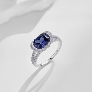 Macro shot of S925 silver ring featuring deep blue oval gemstone and pavé diamonds